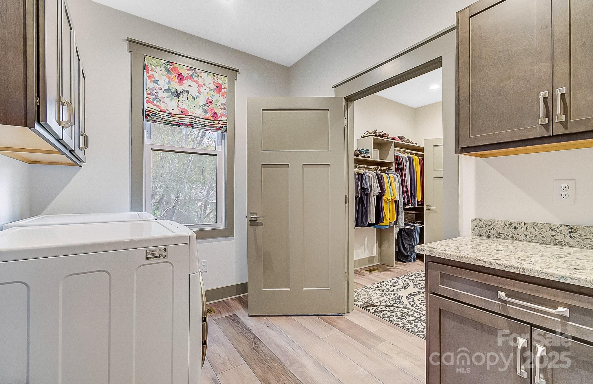 250 Judson Ridge Road Arden, NC 28704 - Photo 12 of 47 a hallway with a stove top oven a refrigerator and washer