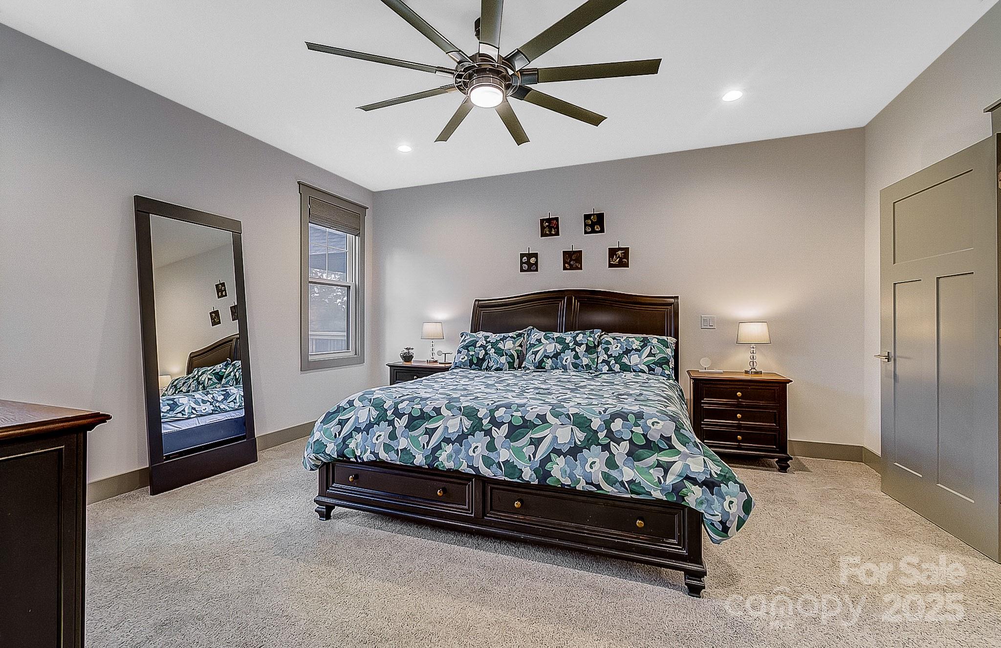 250 Judson Ridge Road Arden, NC 28704 - Photo 31 of 47 a bedroom with a bed and a chandelier