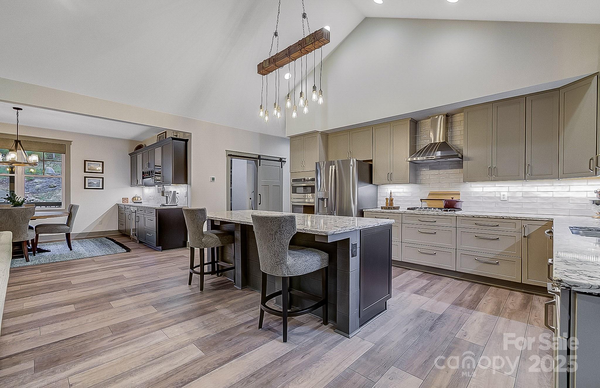 250 Judson Ridge Road Arden, NC 28704 - Photo 40 of 47 a kitchen with granite countertop a sink cabinets and wooden floor