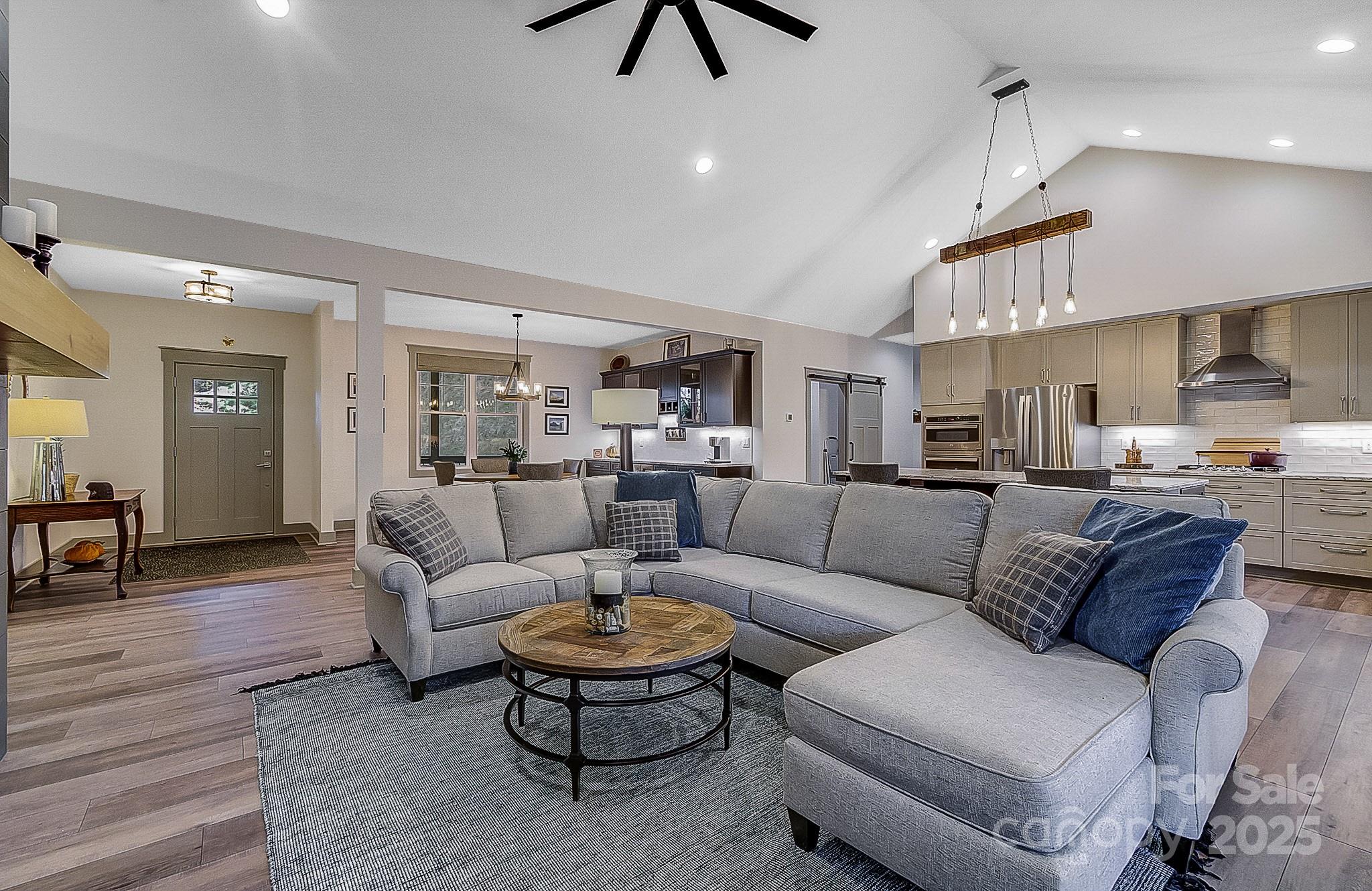 250 Judson Ridge Road Arden, NC 28704 - Photo 42 of 47 a living room with furniture kitchen view and a chandelier