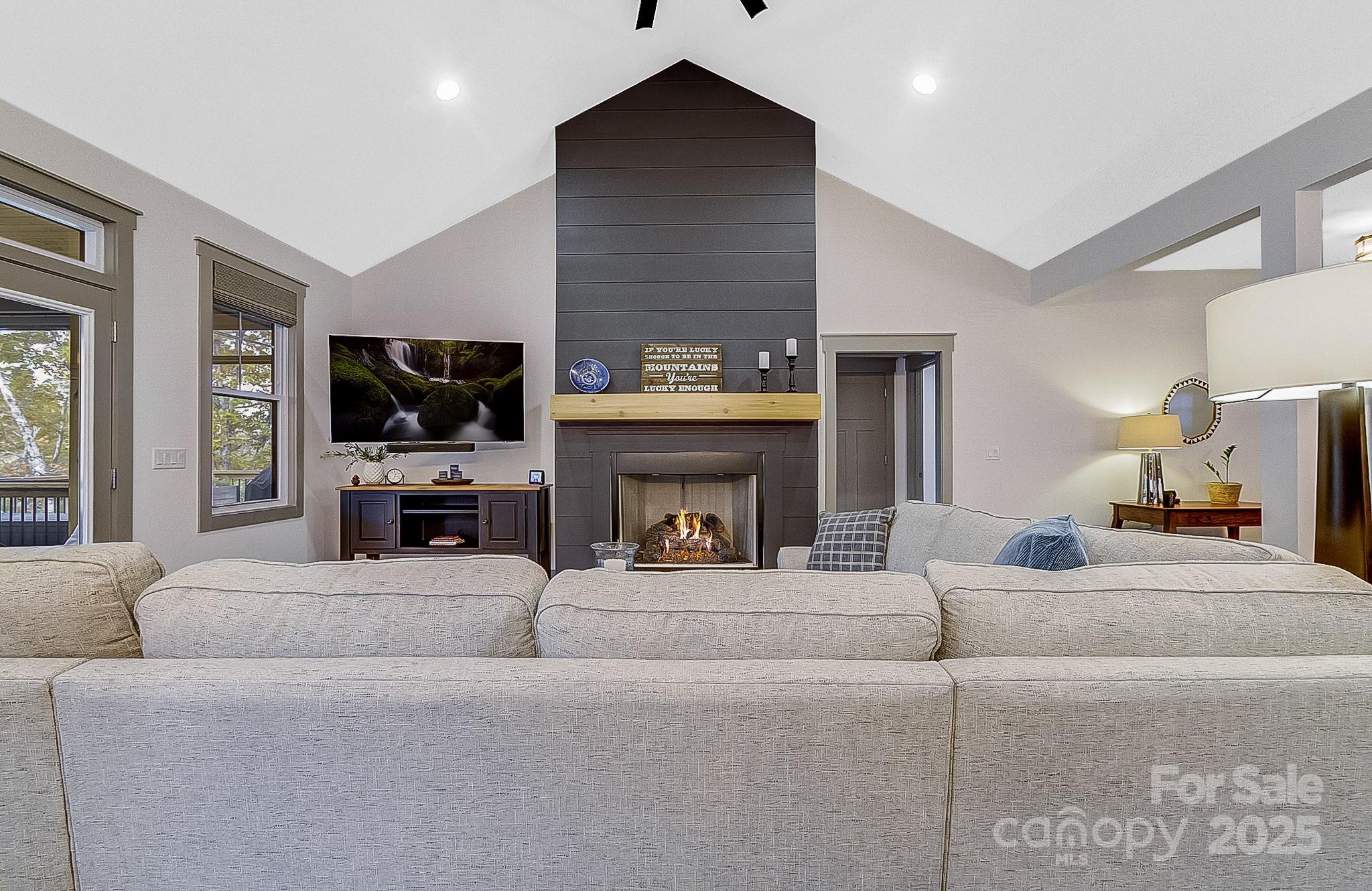 250 Judson Ridge Road Arden, NC 28704 - Photo 43 of 47 a living room with furniture a fireplace and a flat screen tv