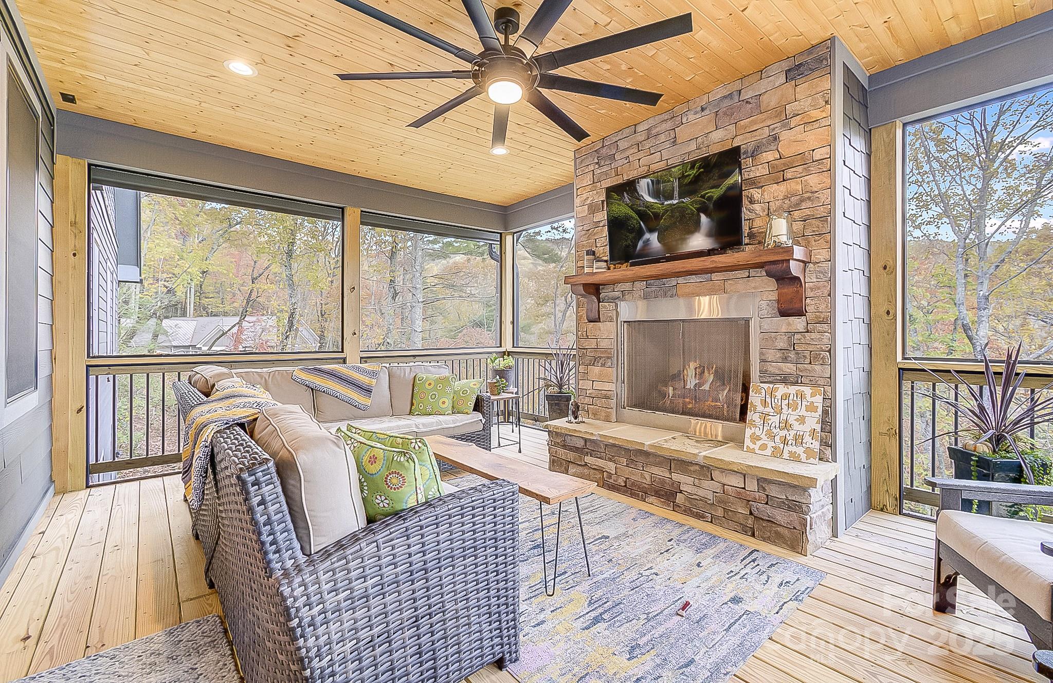 250 Judson Ridge Road Arden, NC 28704 - Photo 7 of 47 a living room with furniture a large window and a fireplace