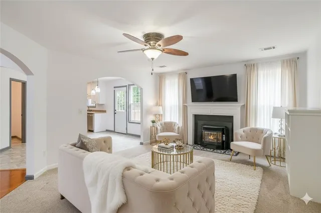 a living room with furniture a fireplace and a flat screen tv