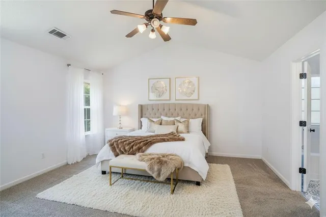 an empty room with wooden floor closet and windows