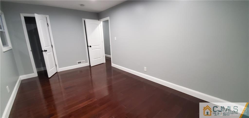 10 Huntington Road Edison, NJ 08820 - Photo 11 of 32 an empty room with wooden floor and a window