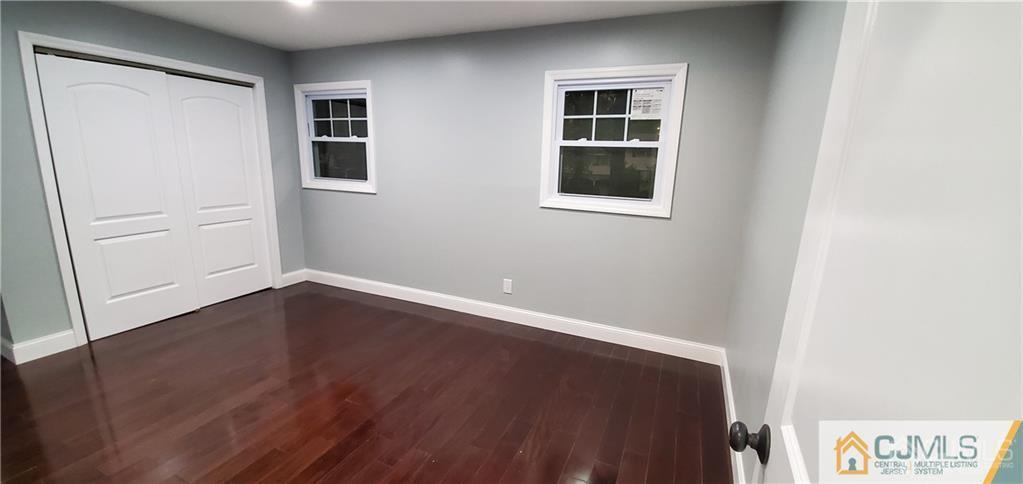 10 Huntington Road Edison, NJ 08820 - Photo 13 of 32 an empty room with wooden floor and windows