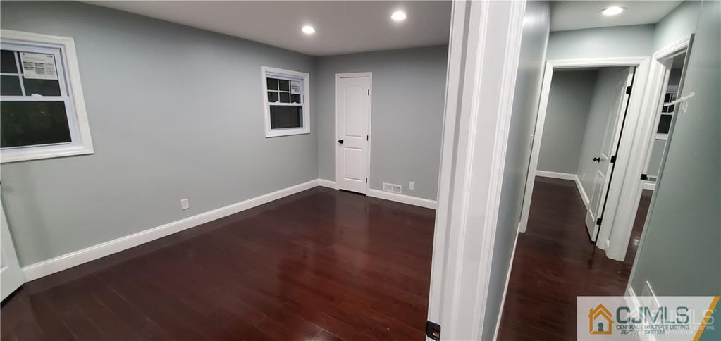 10 Huntington Road Edison, NJ 08820 - Photo 17 of 32 an empty room with wooden floor and entrance