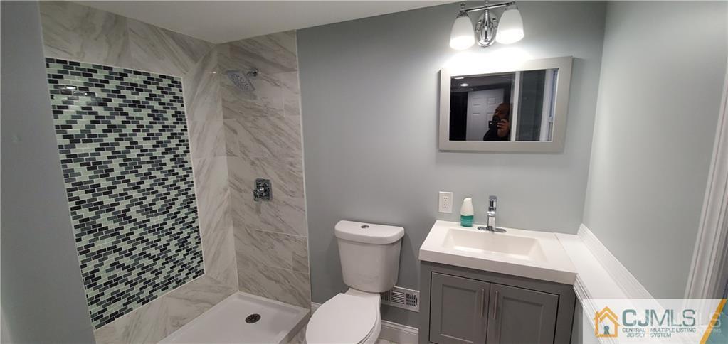 10 Huntington Road Edison, NJ 08820 - Photo 22 of 32 a bathroom with a sink a toilet and shower