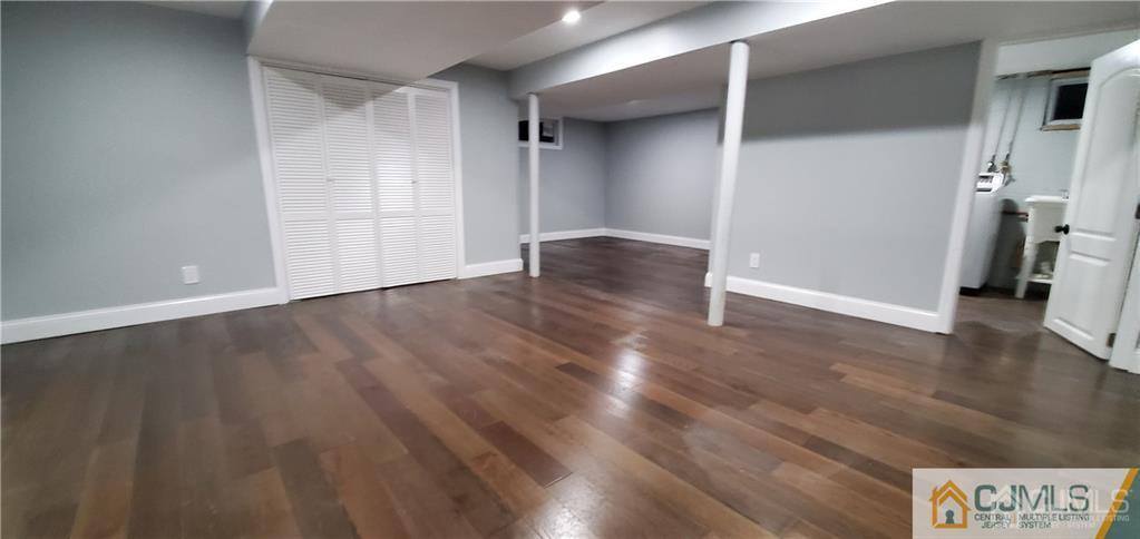 10 Huntington Road Edison, NJ 08820 - Photo 26 of 32 a view of an empty room with wooden floor and a window