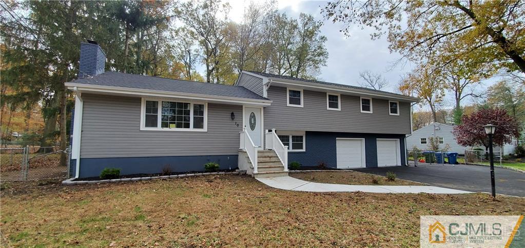 10 Huntington Road Edison, NJ 08820 - Photo 28 of 32 a front view of a house with a yard and garage
