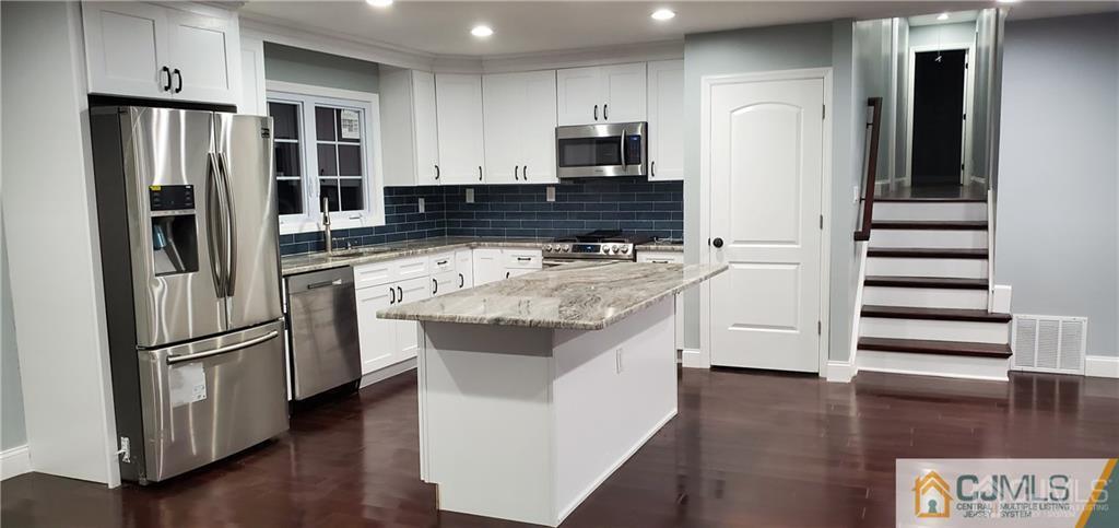 10 Huntington Road Edison, NJ 08820 - Photo 6 of 32 a kitchen with stainless steel appliances a refrigerator and a stove top oven