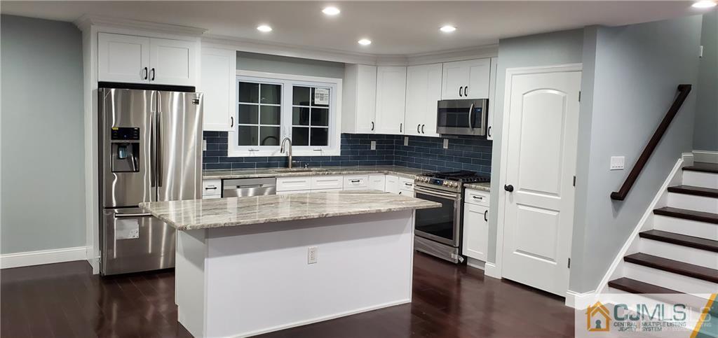 10 Huntington Road Edison, NJ 08820 - Photo 9 of 32 a kitchen with stainless steel appliances granite countertop a refrigerator and a stove top oven