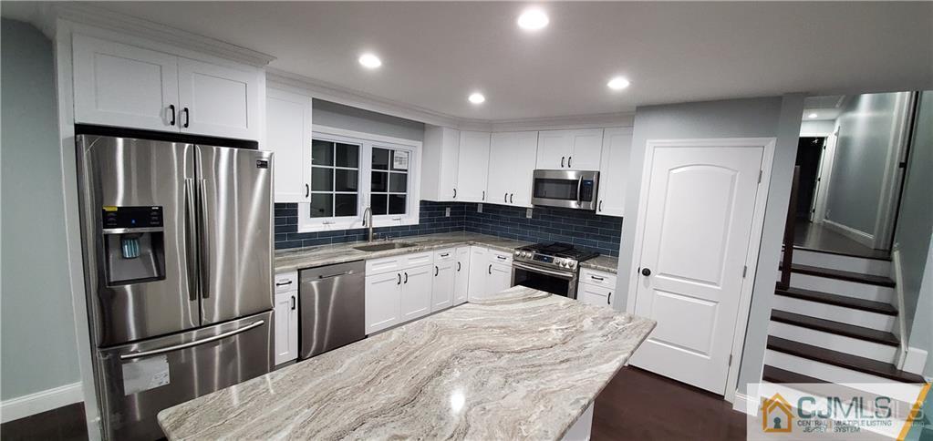10 Huntington Road Edison, NJ 08820 - Photo 10 of 32 a kitchen with granite countertop stainless steel appliances a refrigerator stove top oven and sink