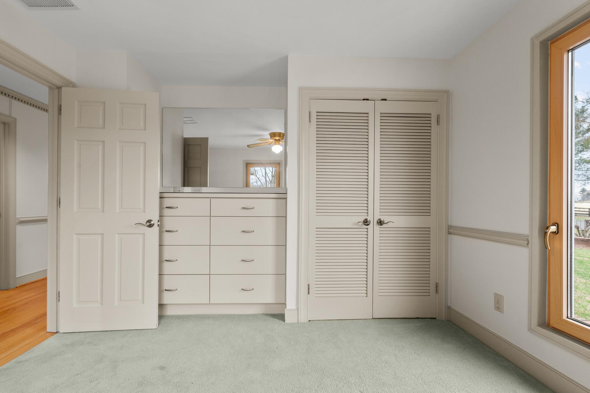 94 Old Hollow Road Sperryville, VA 22740 - Photo 14 of 38 an empty room with closet and mirror