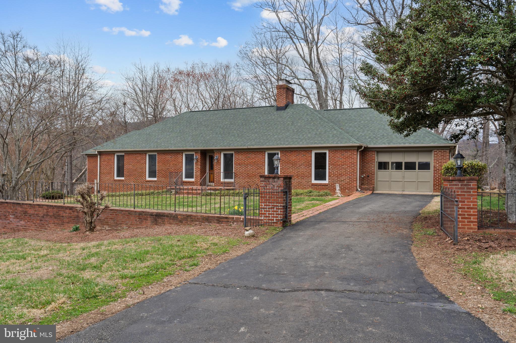 94 Old Hollow Road Sperryville, VA 22740 - Photo 4 of 38 a front view of a house with a garden and yard