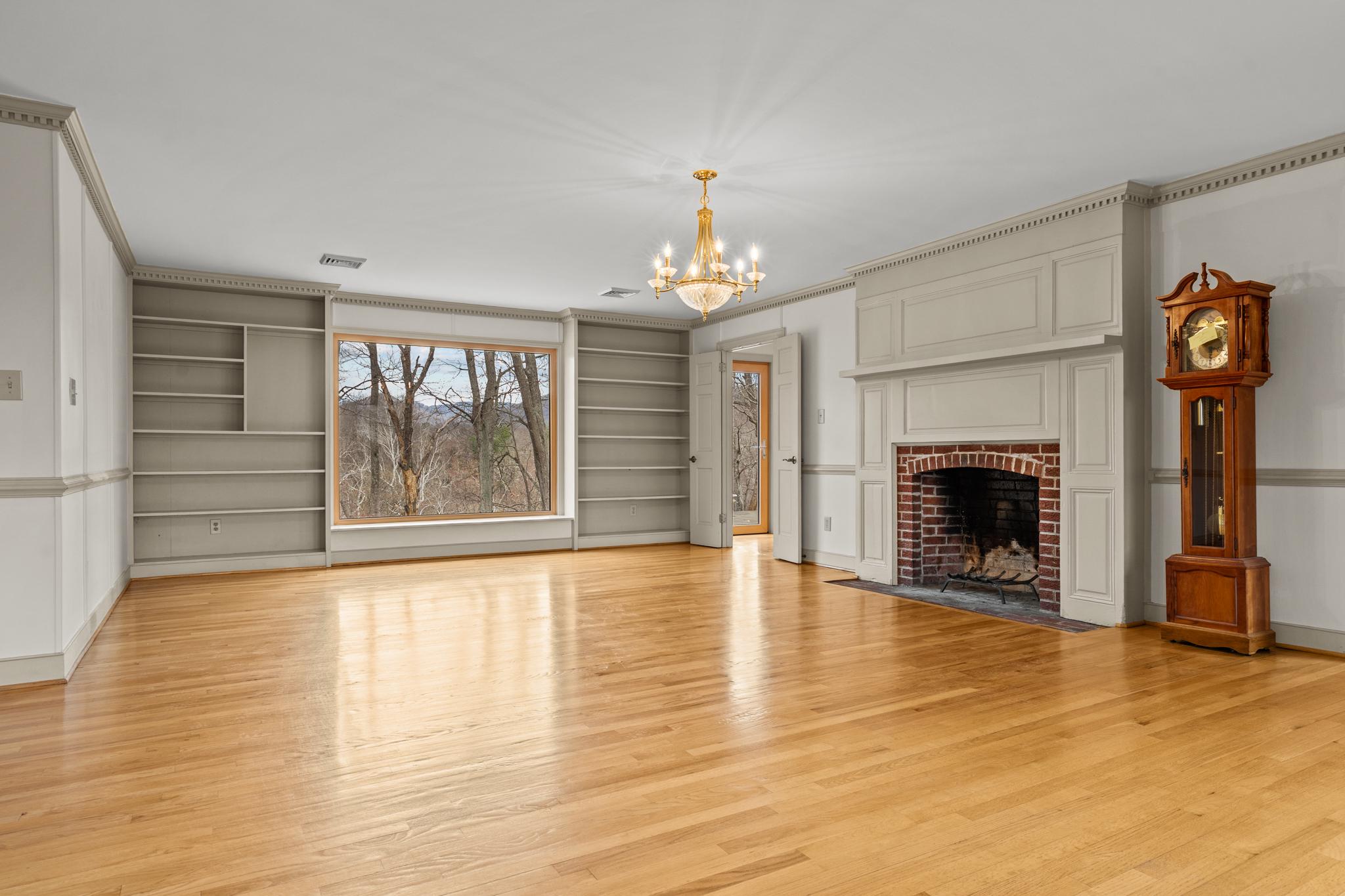 94 Old Hollow Road Sperryville, VA 22740 - Photo 5 of 38 wooden floor fireplace and windows in an empty room