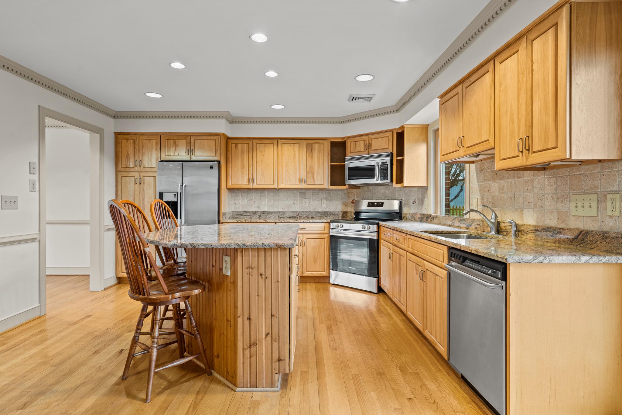 94 Old Hollow Road Sperryville, VA 22740 - Photo 8 of 38 a kitchen with stainless steel appliances granite countertop wooden cabinets a stove top oven a sink and dishwasher