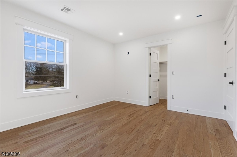759 Mechlin Corner Road Hampton, NJ 08827 - Photo 40 of 45 an empty room with wooden floor and windows