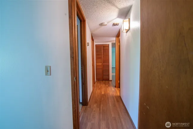 a view of a hallway with wooden floor