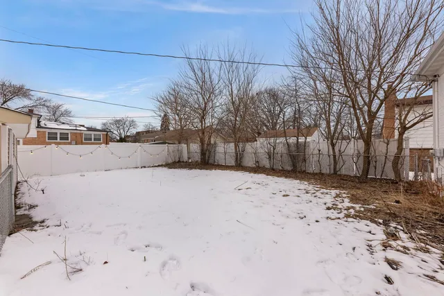 a view of a yard covered in snow