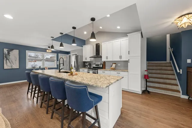 a kitchen with stainless steel appliances granite countertop counter space a sink refrigerator and cabinets
