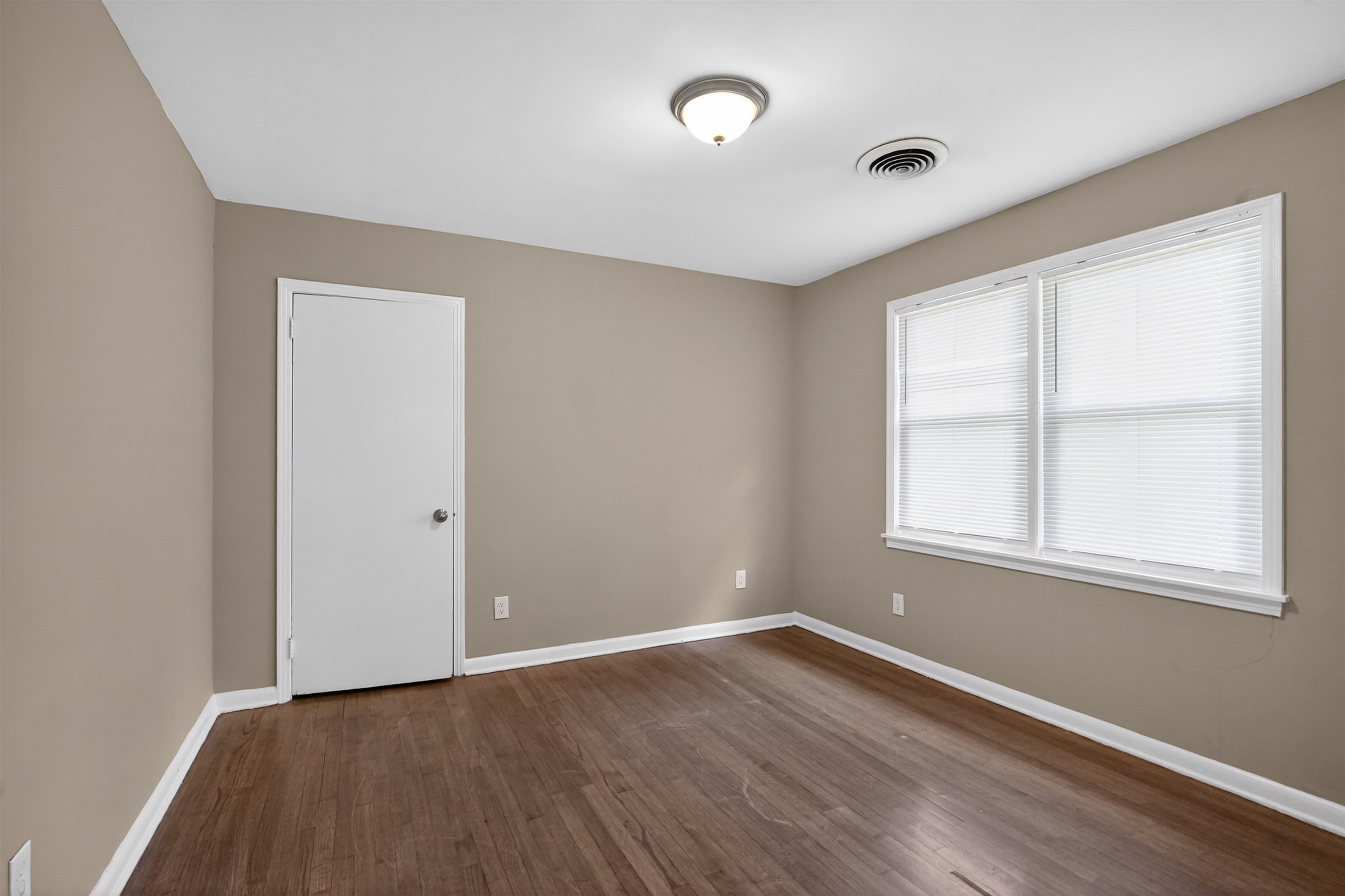 1514 Mt Moriah Road Memphis, TN 38117 - Photo 15 of 34 Interior space featuring wood-finish flooring, neutral wall paint, and white trim