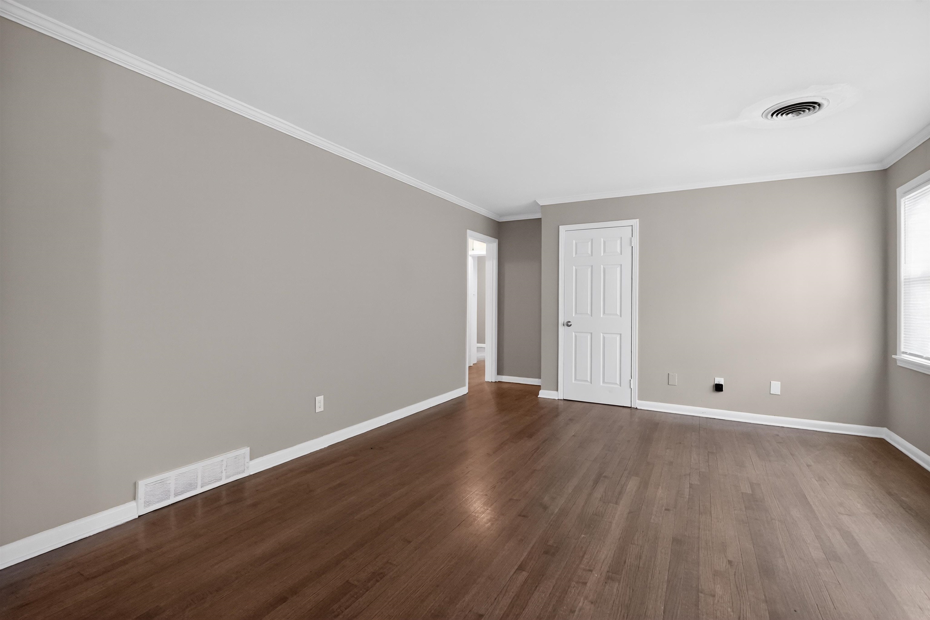 1514 Mt Moriah Road Memphis, TN 38117 - Photo 18 of 34 Warm wood-finish flooring complements neutral wall tones and white crown molding