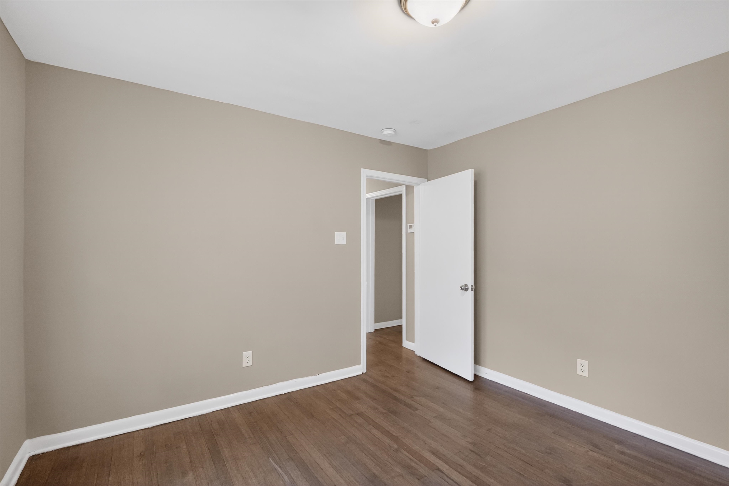 1514 Mt Moriah Road Memphis, TN 38117 - Photo 19 of 34 Interior room with wood-finish flooring, light tan walls, and white trim