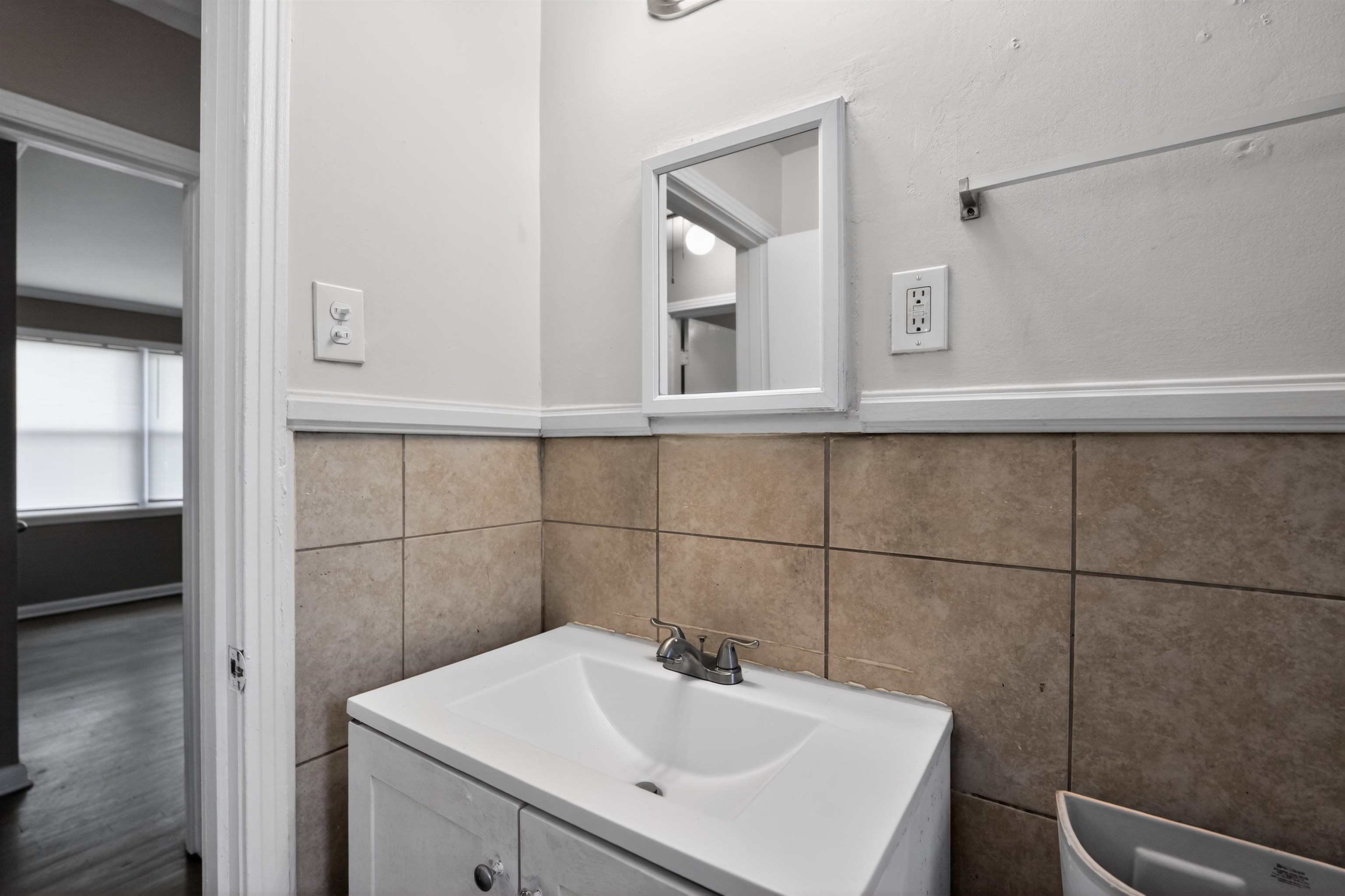 1514 Mt Moriah Road Memphis, TN 38117 - Photo 31 of 34 Bathroom vanity with an integrated sink, dual-handle faucet, and medicine cabinet