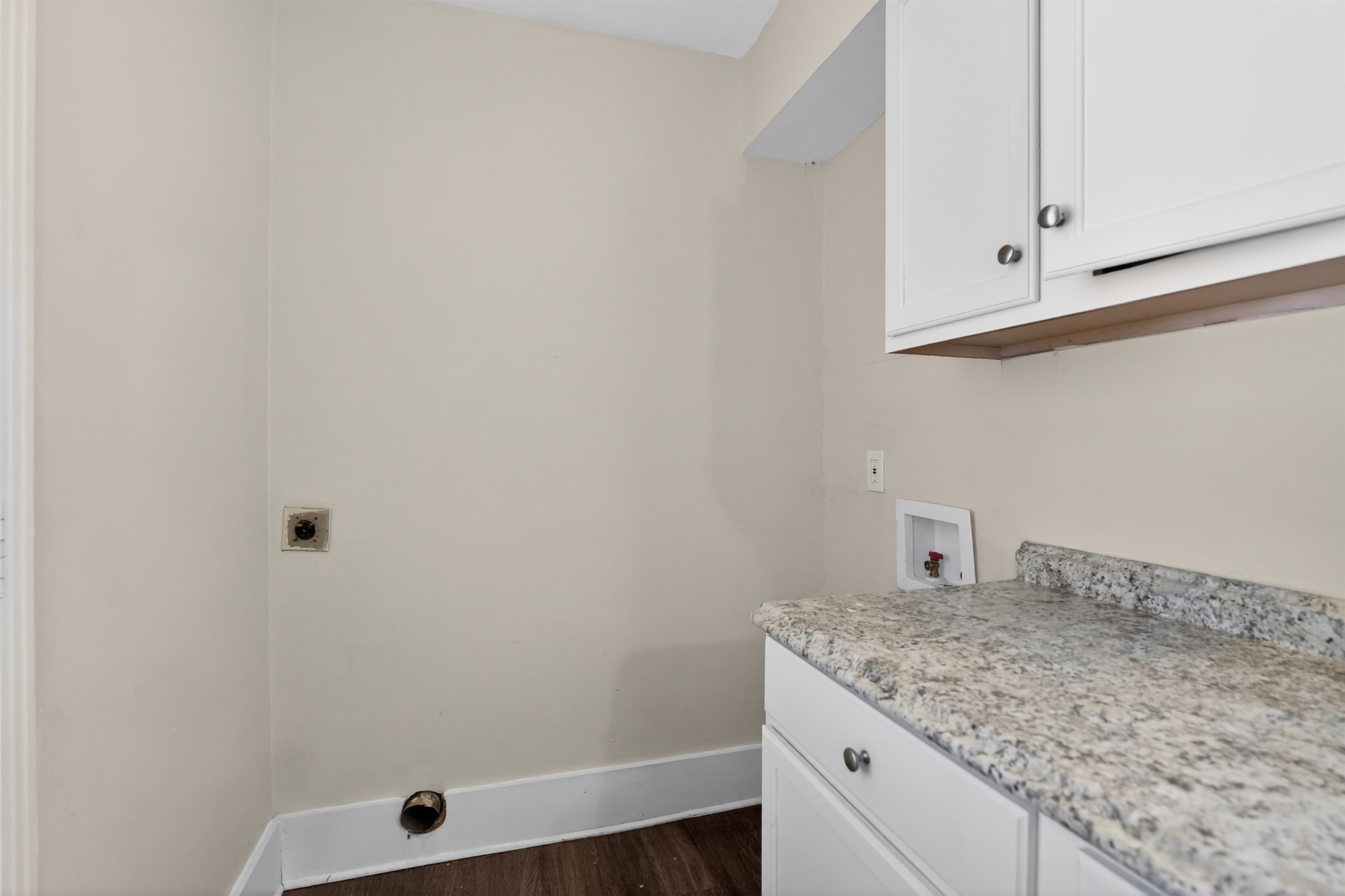 1514 Mt Moriah Road Memphis, TN 38117 - Photo 32 of 34 Utility area featuring white cabinetry, a granite-finish countertop, wood-finish flooring, and light-toned walls