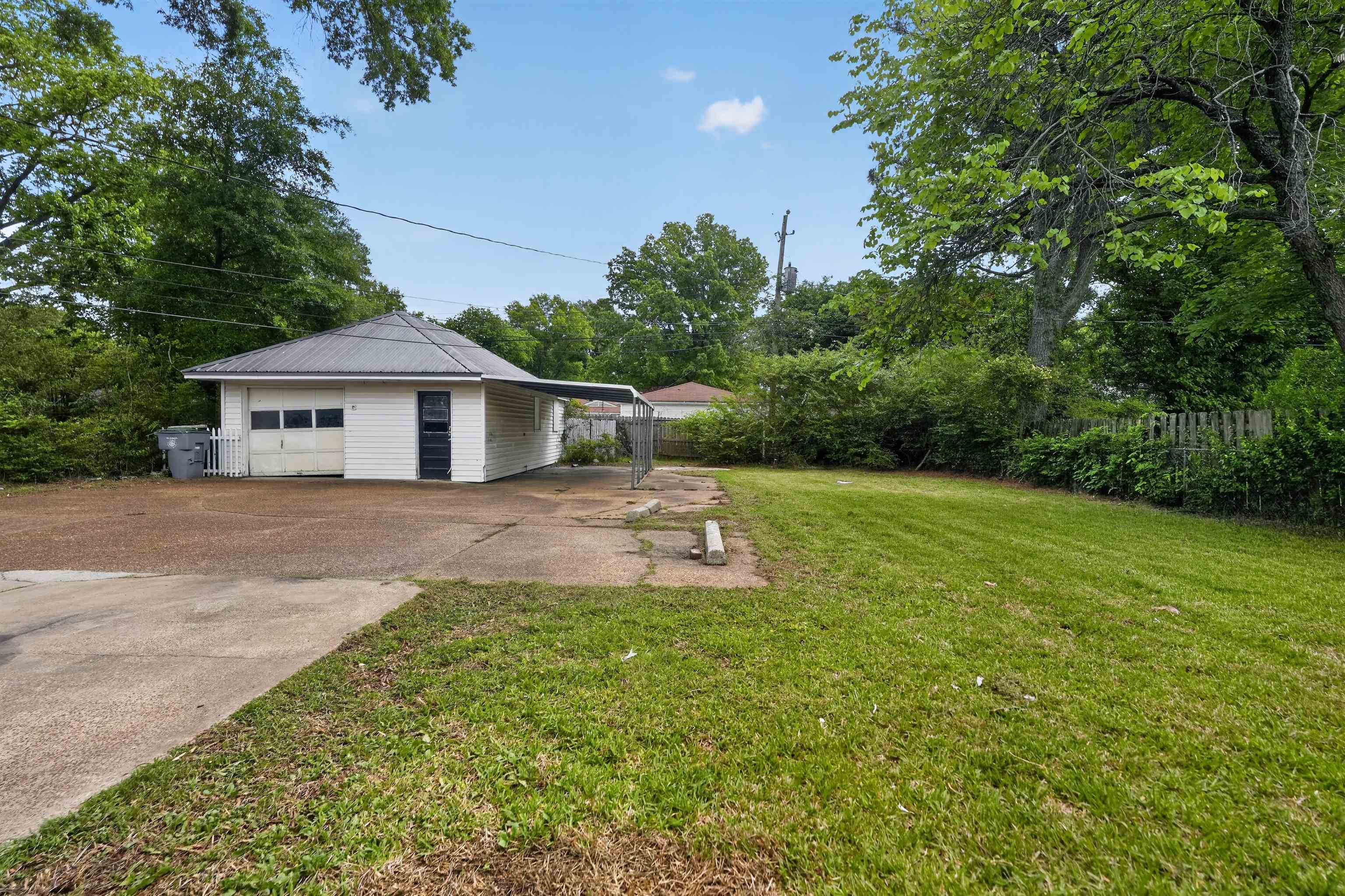 1514 Mt Moriah Road Memphis, TN 38117 - Photo 5 of 34 Detached garage structure featuring a metal roof and an attached carport