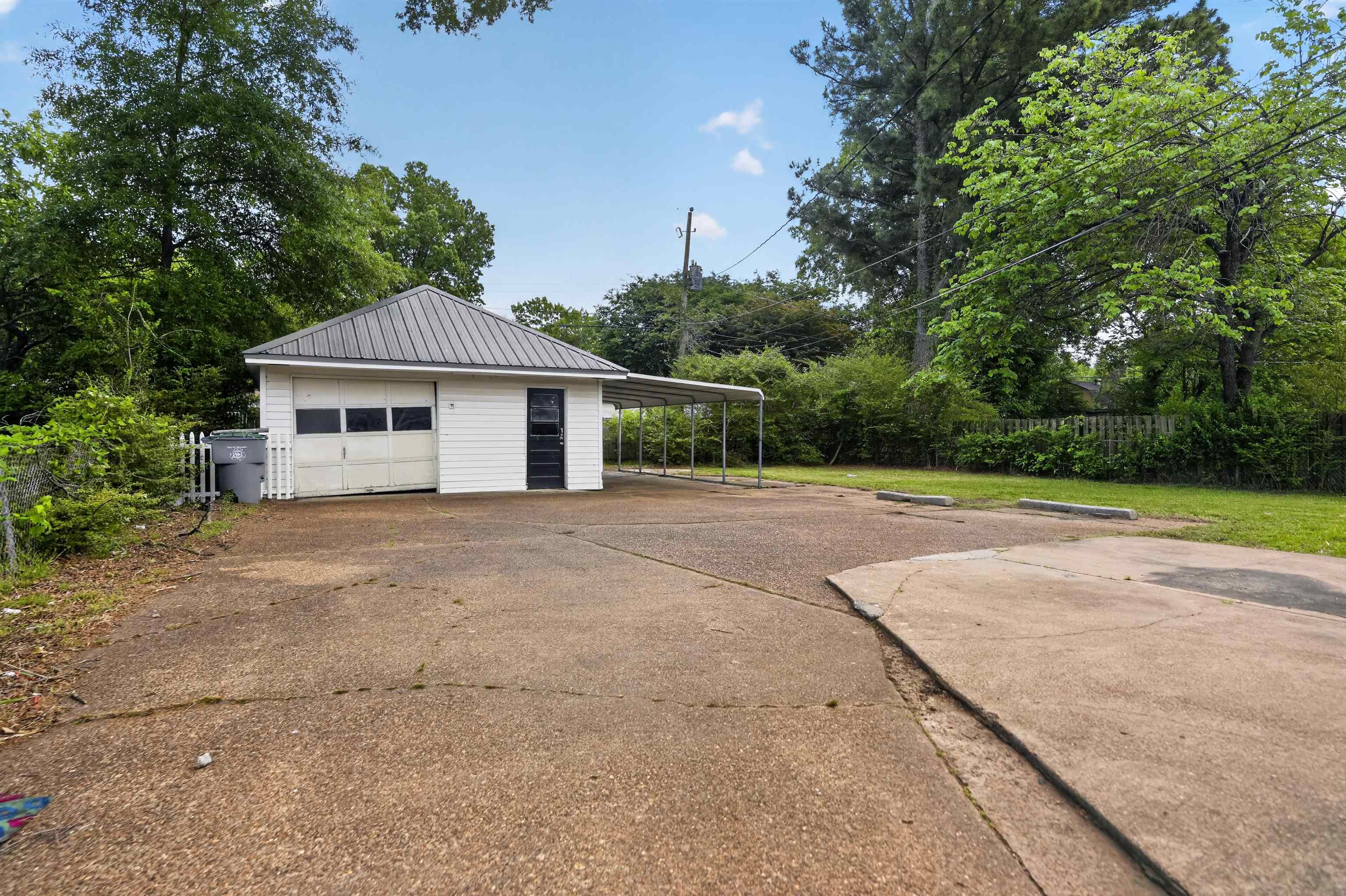 1514 Mt Moriah Road Memphis, TN 38117 - Photo 8 of 34 Detached structure with white siding and a dark metal roof