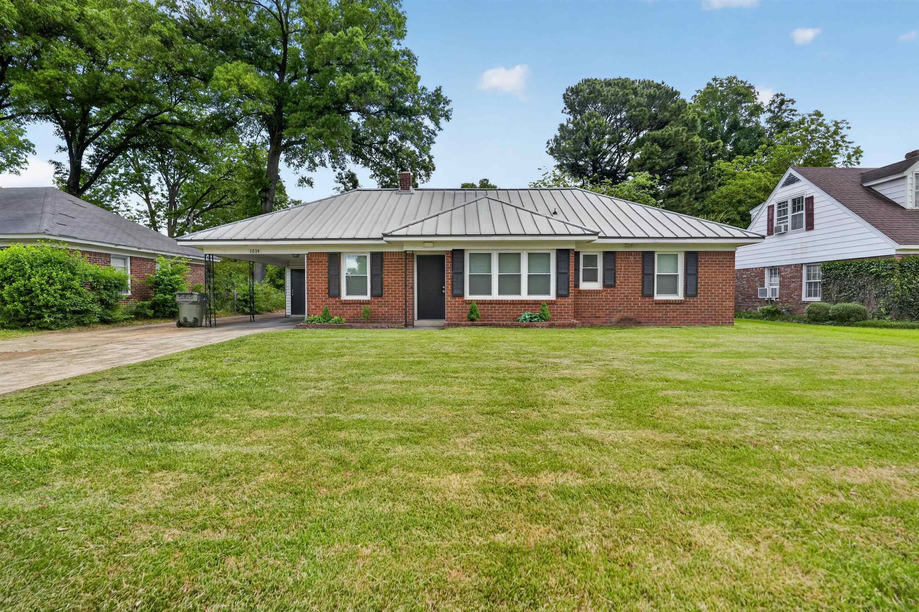 1514 Mt Moriah Road Memphis, TN 38117 - Photo 10 of 34 Brick exterior with a standing seam metal roof and a covered carport