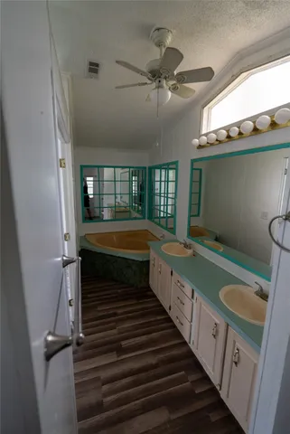 a bathroom with 2 sink and a bathtub