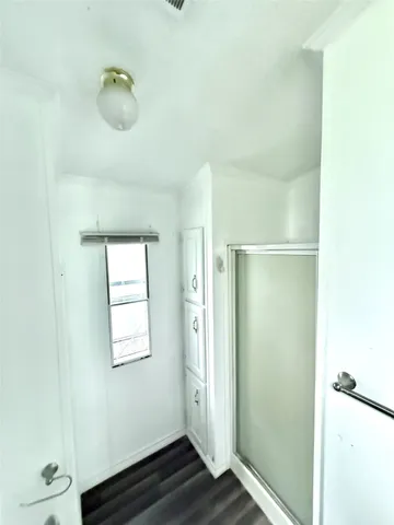 a bathroom with a glass shower door