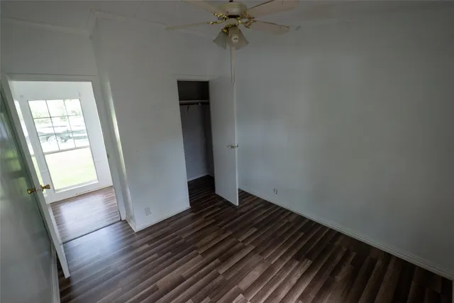 a view of a room with wooden floor