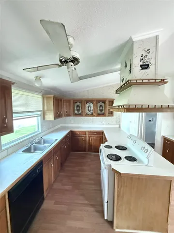 a kitchen with stainless steel appliances granite countertop a sink and a stove