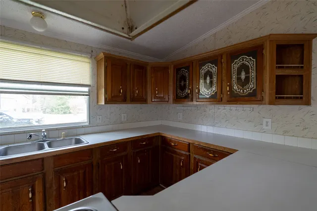 a kitchen with a sink and cabinets