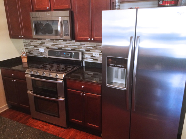 1111 West 15th Street, Unit 126 Chicago, IL 60608 - Photo 12 of 24 a kitchen with a stove microwave and refrigerator