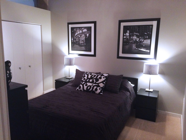 1111 West 15th Street, Unit 126 Chicago, IL 60608 - Photo 15 of 24 a large bed in a bedroom next to a lamp