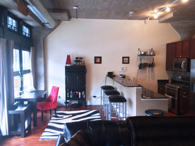 1111 West 15th Street, Unit 126 Chicago, IL 60608 - Photo 4 of 24 a living room with furniture and wooden floor