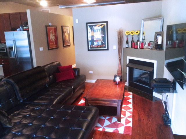 1111 West 15th Street, Unit 126 Chicago, IL 60608 - Photo 6 of 24 a living room with furniture and a fireplace