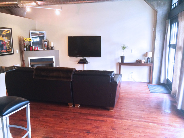 1111 West 15th Street, Unit 126 Chicago, IL 60608 - Photo 8 of 24 a living room with furniture and a flat screen tv