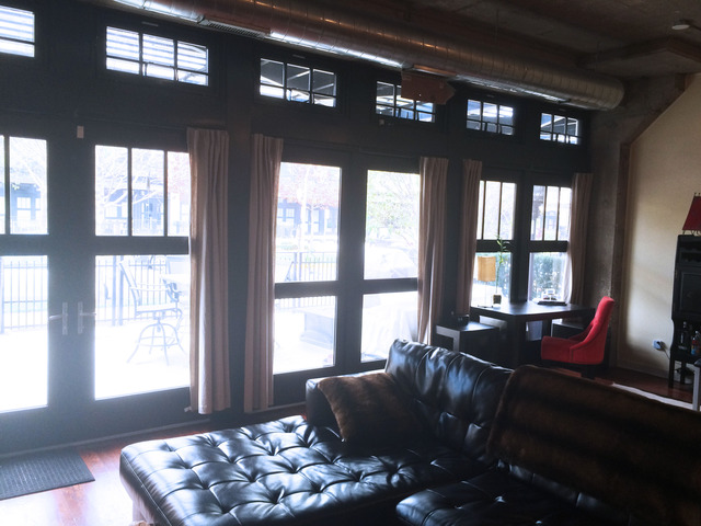 1111 West 15th Street, Unit 126 Chicago, IL 60608 - Photo 9 of 24 a living room with furniture and a flat screen tv