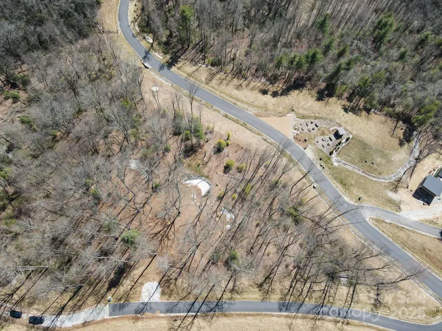 a view of a yard with wooden fence