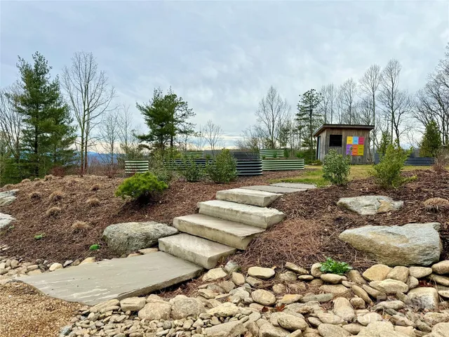a front view of a house with a yard and outdoor seating