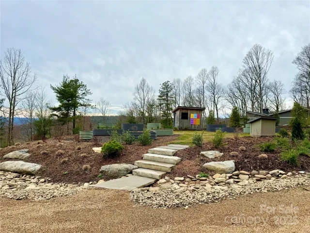 a view of a yard with wooden fence