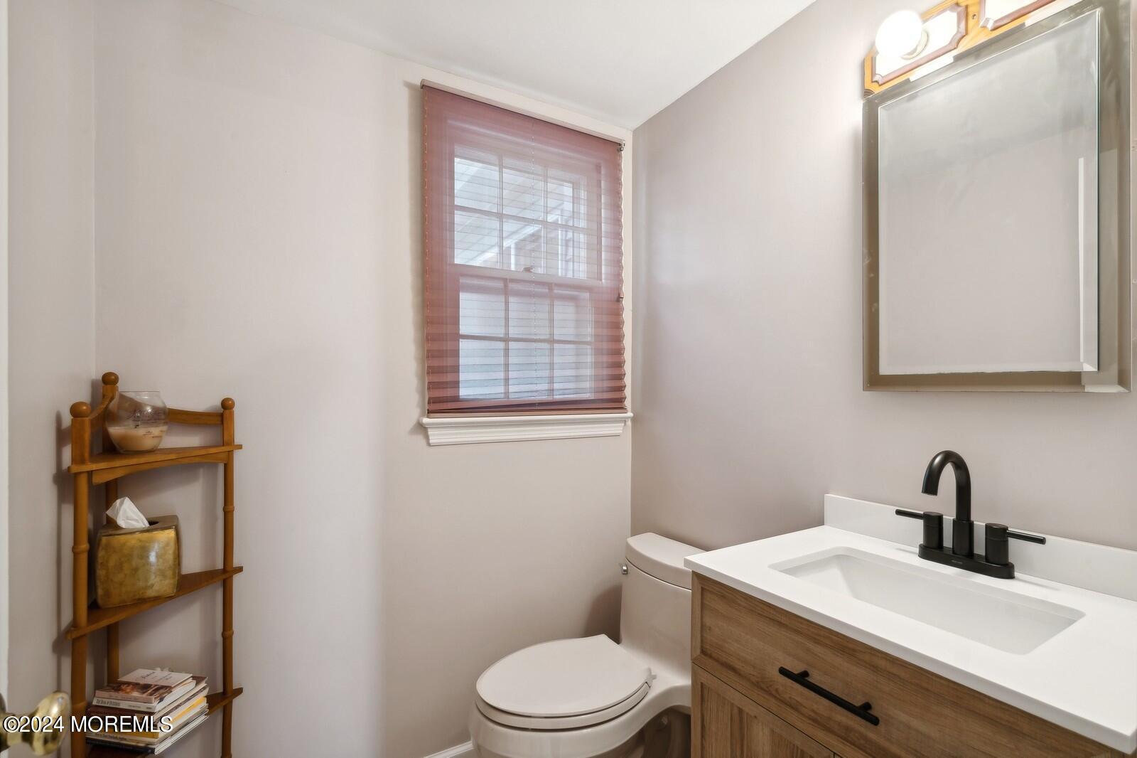 57 Pelican Road Middletown, NJ 07748 - Photo 6 of 49 a bathroom with a toilet a sink and mirror