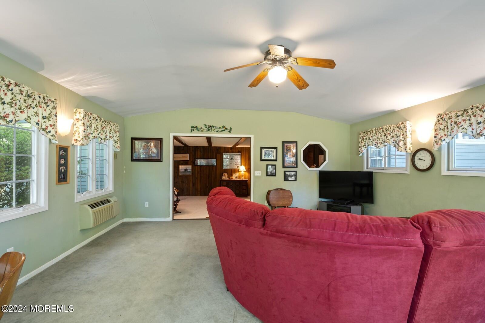 57 Pelican Road Middletown, NJ 07748 - Photo 9 of 49 a living room with furniture a fireplace and a flat screen tv