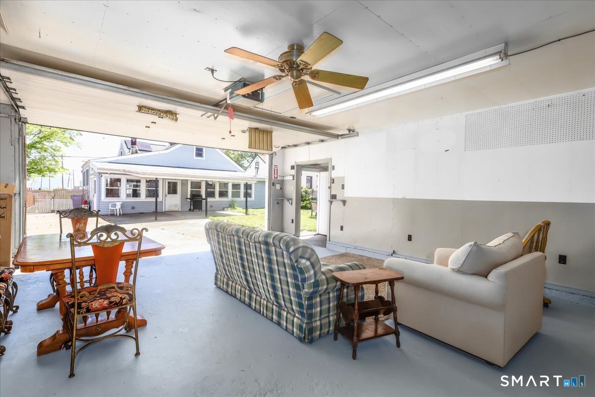 306 Welton Street Hamden, CT 06517 - Photo 38 of 38 a living room with furniture a ceiling fan and a large window